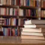 Close up of books on desk in library.